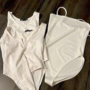 3 white bodysuits